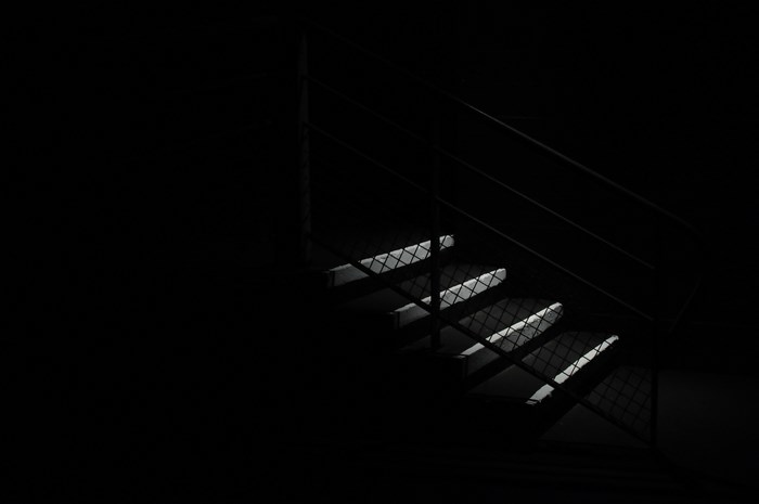 Dark staircase with light on steps