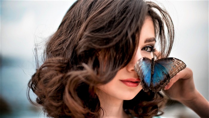 Brunette Woman with Blue Butterfly on Face