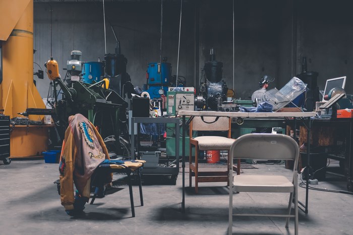Workshop with machinery, chairs, and a jacket