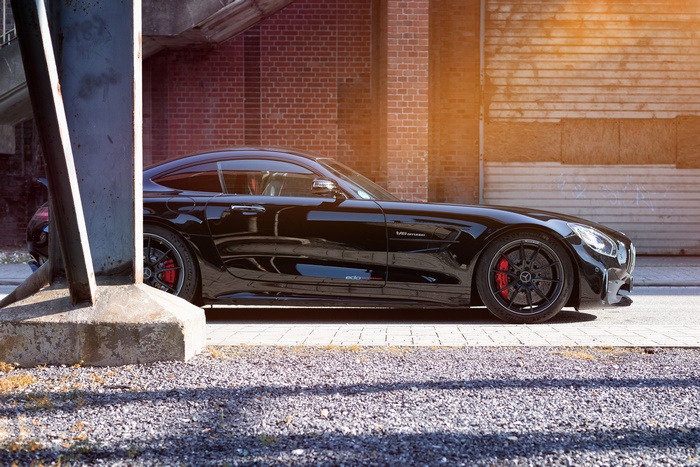 Black Mercedes-AMG GT R parked by brick building