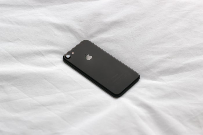 Black iPhone 7 on a white textured surface