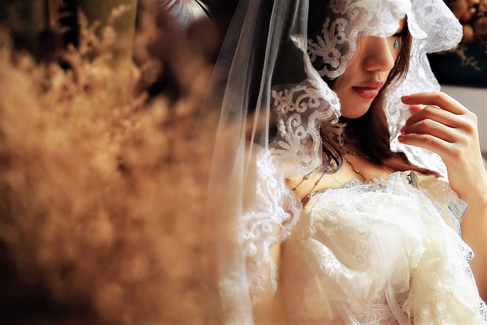 Woman in a wedding veil with a tear