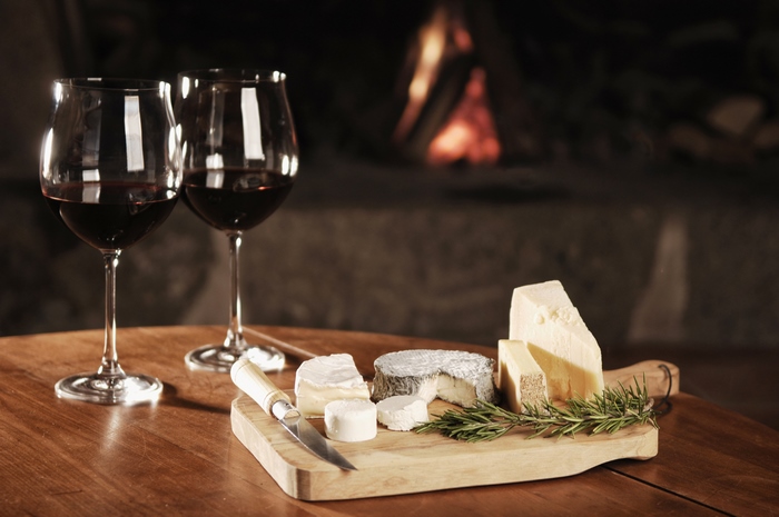Wine Glasses and Cheese Platter by Fireplace