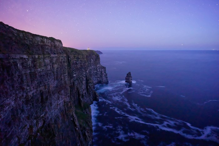 Cliffs of Moher at night with stars and sea