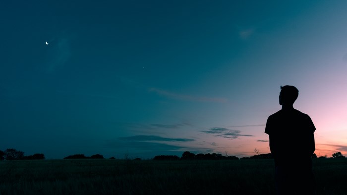 Silhouette of Man Watching Night Sky at Sunset