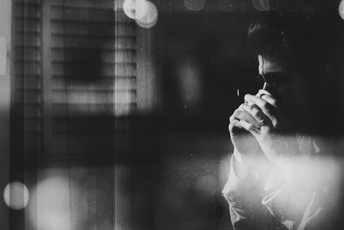 Moody Black and White Portrait of Man with Coffee