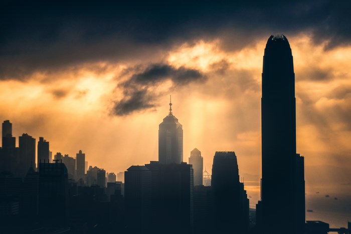 Cityscape with dramatic clouds and sunbeams