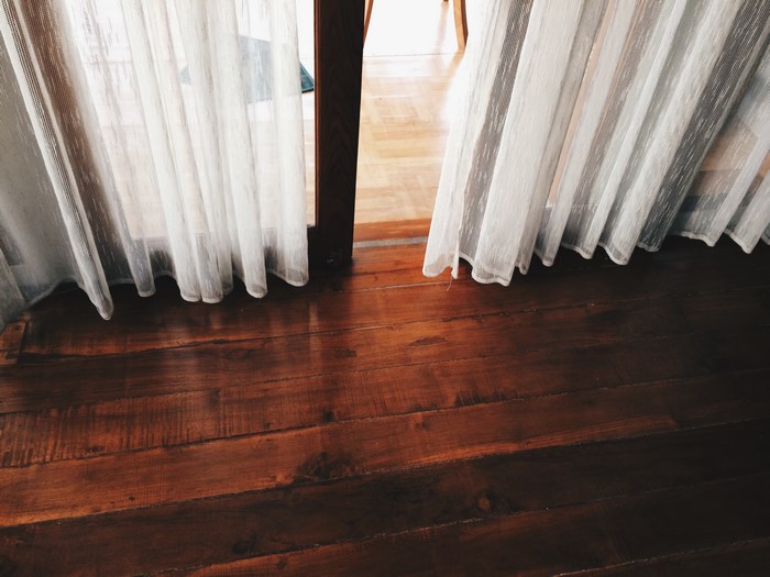 Wooden floor with white curtains
