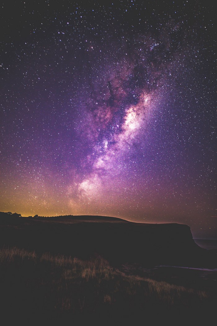 Milky Way over a dark landscape