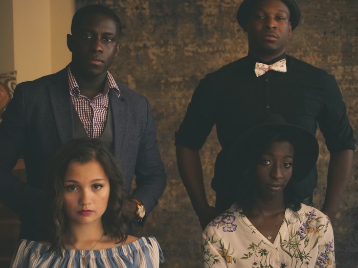 Four people posing for a formal photo