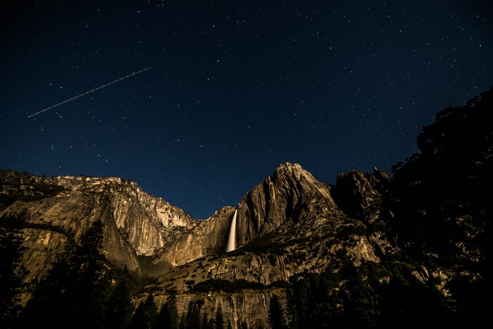 Night Sky Over Waterfall and Mountain Landscape