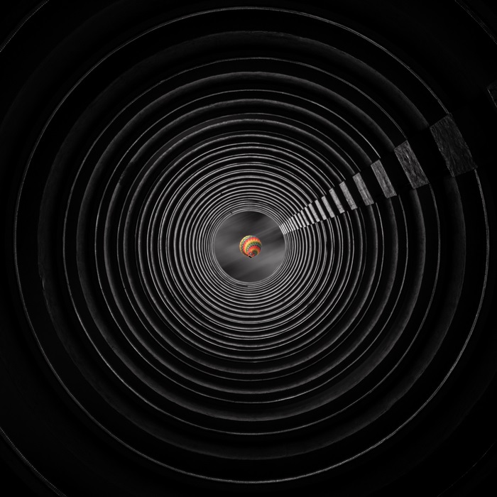 Hot air balloon in a dark circular tunnel