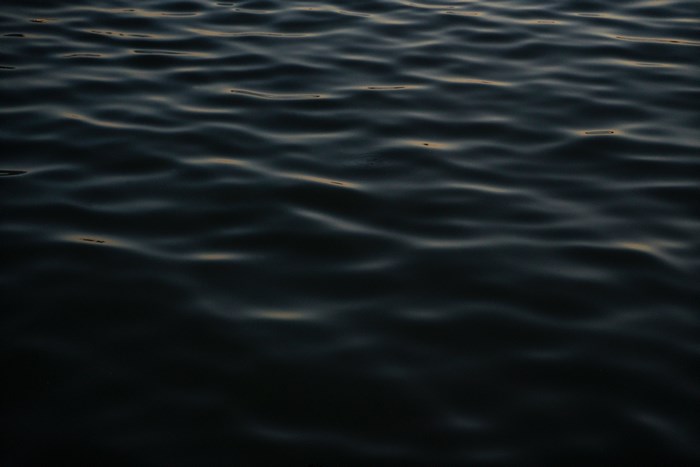 Dark water surface with ripples