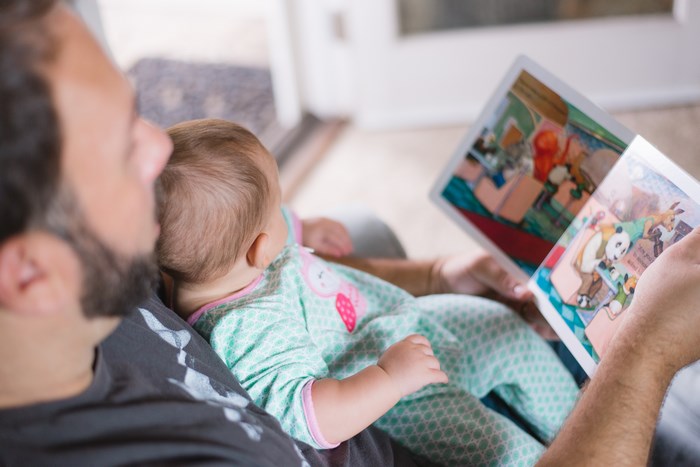 Father reading a book to his baby