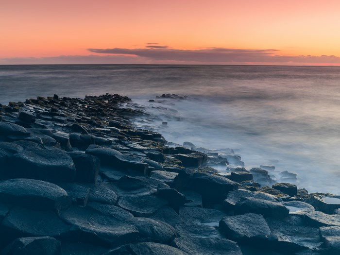 Giant's Causeway coast at sunrise with long exposure sea