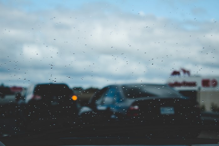 Cars on a rainy day with a building in the background