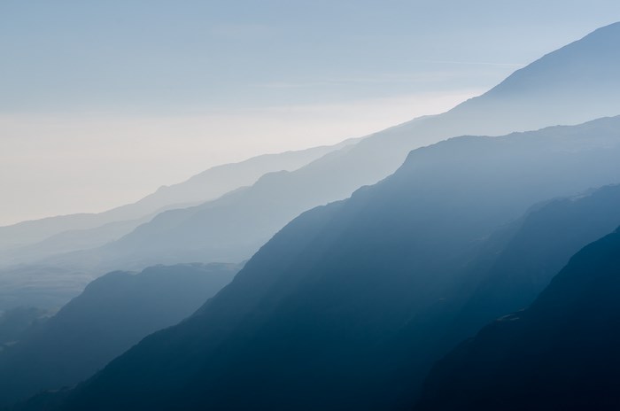 Blue mountain range shrouded in mist