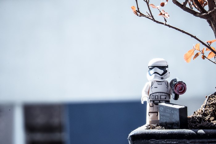Lego Stormtrooper with a gun near a bonsai tree