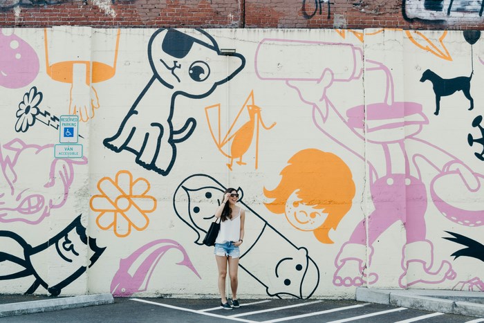 Woman Poses in Front of Portland Street Art Mural
