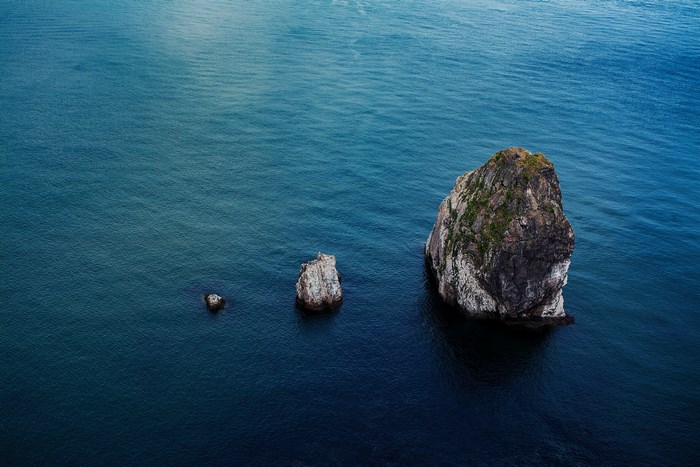 Three rocks in the blue ocean