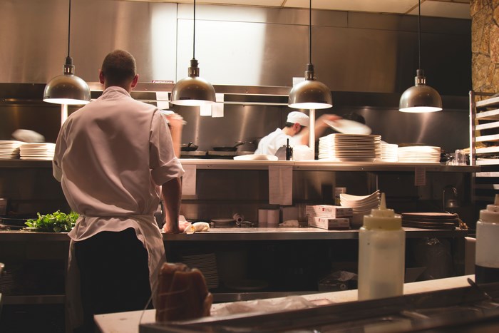 Chefs working in a busy restaurant kitchen