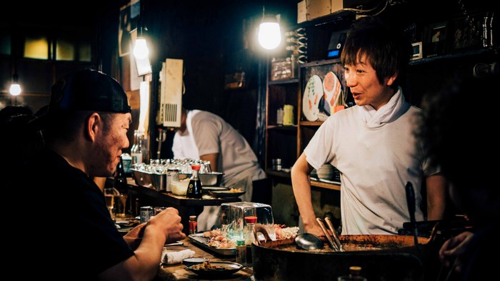 Bartender and customer at a bar
