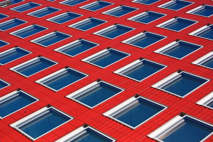 Red tiled facade with repeating blue windows
