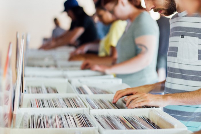 People browsing records in a music shop