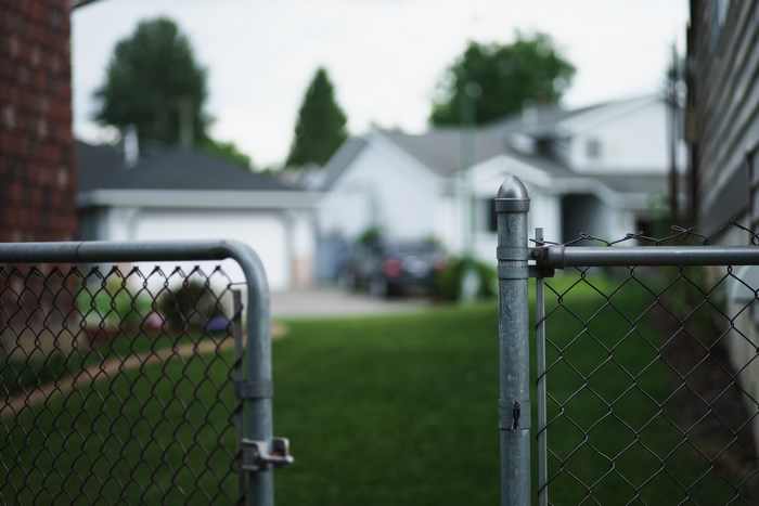 Chain link fence gate in a suburban yard