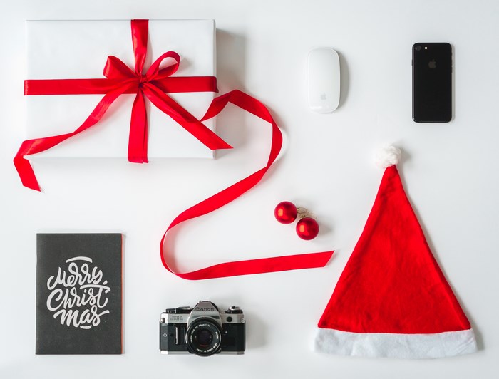 Christmas flatlay with gift, camera, and iPhone