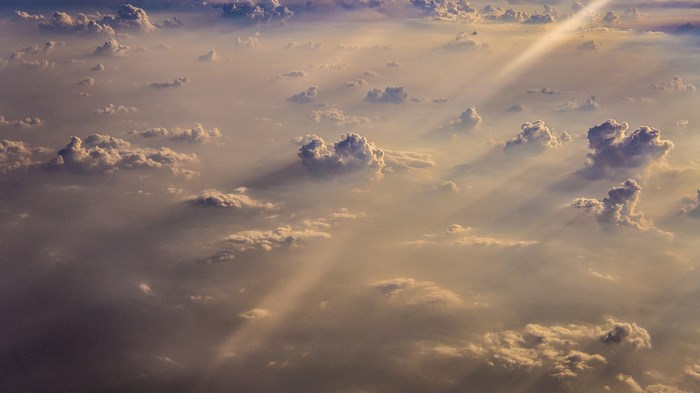 Sunlight beams through clouds from above