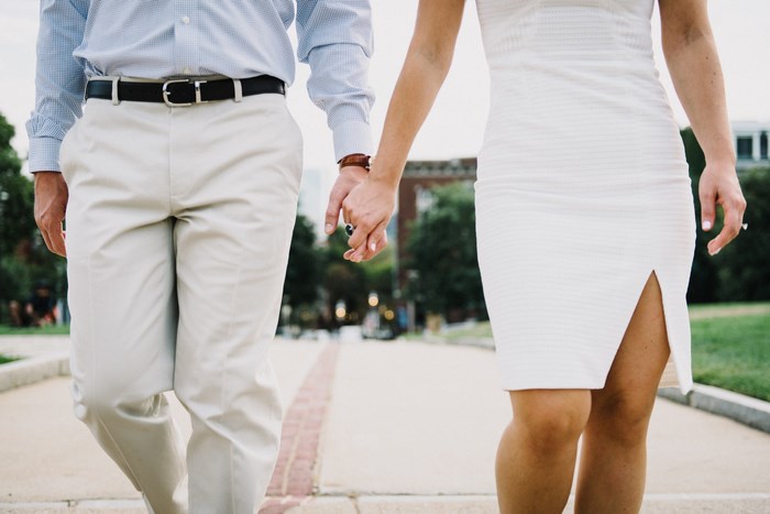 Couple holding hands walking outdoors