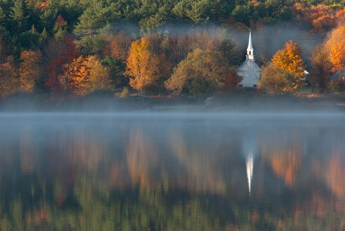 Foggy Lake Reflection with Autumn Trees and White Church