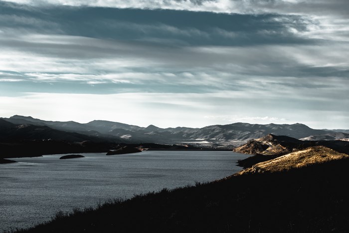 Lake and mountains under a cloudy sky
