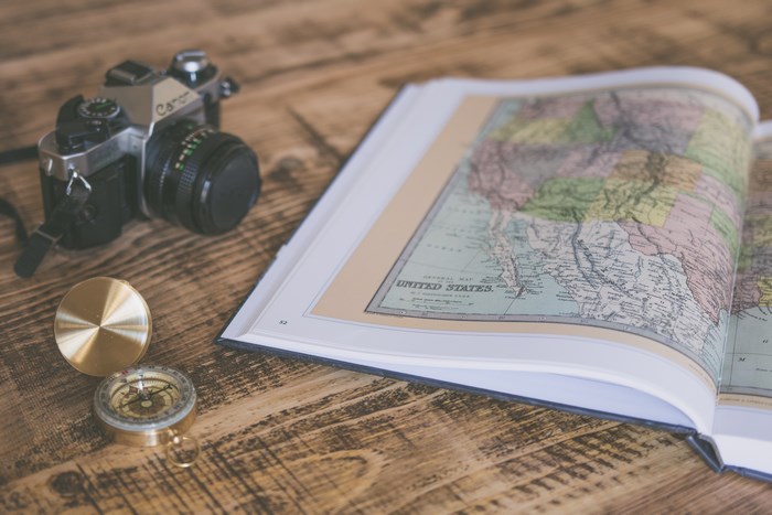 Canon film camera, compass, and map of the United States