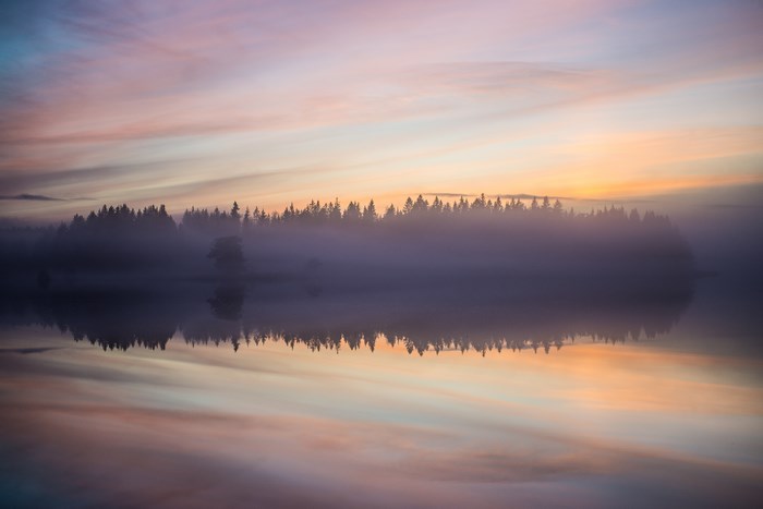 Misty Sunrise over a Calm Swedish Lake