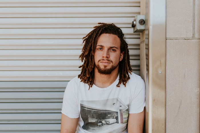 Man with dreadlocks in urban city setting
