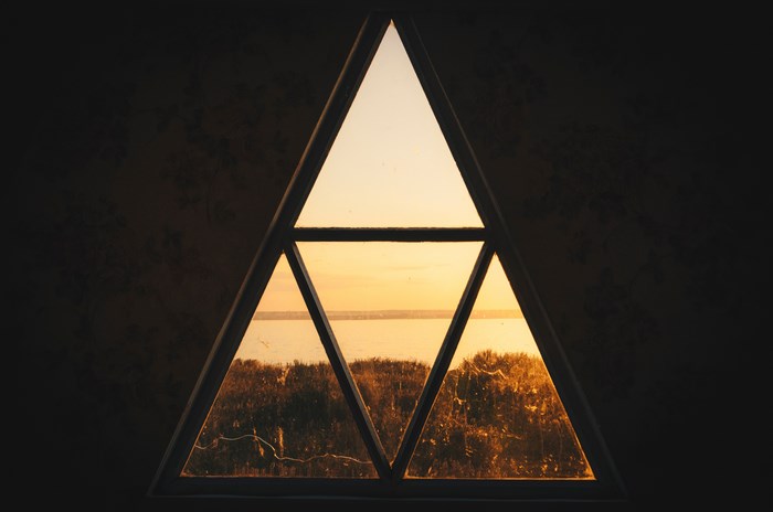 Triangle window view of a lake at sunset