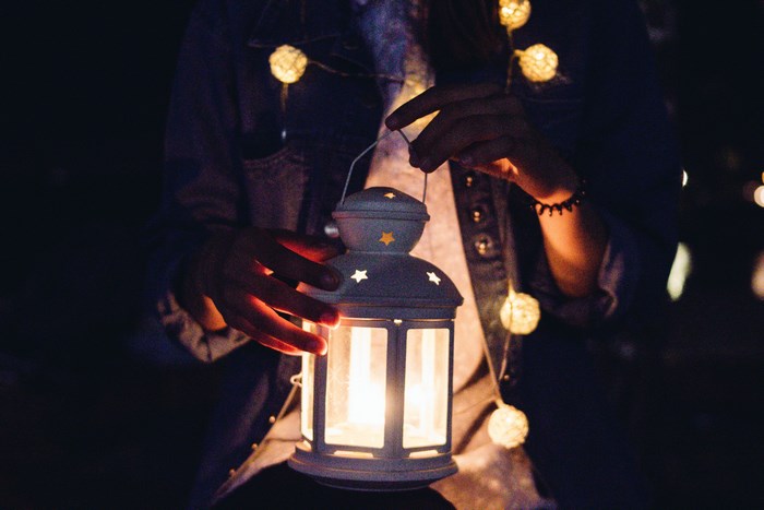 Girl holding a lantern with string lights