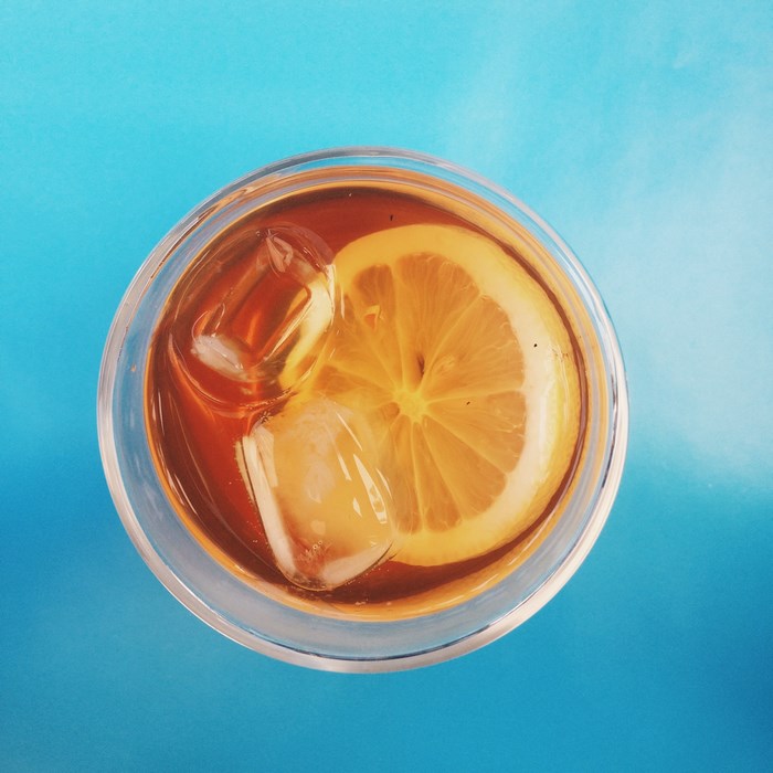 Top view of iced tea with lemon and ice