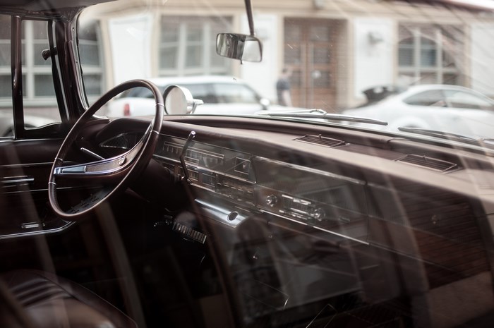 Interior of a classic car with steering wheel and dashboard