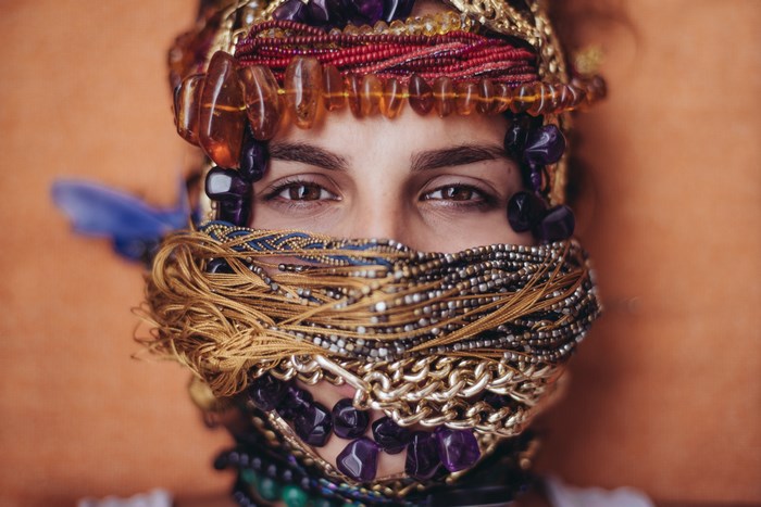 Woman covered in ornate jewelry and beads