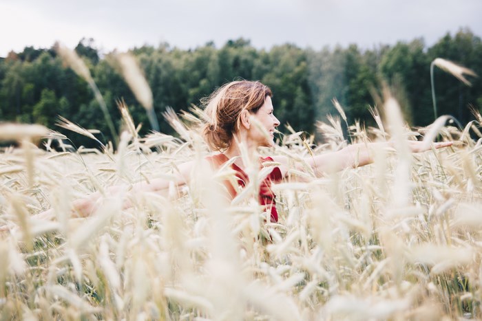 Woman in red dress in a wheat field