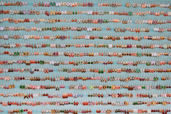 Colorful earrings displayed on a blue background