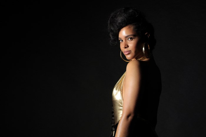 Alicia Keys in a gold dress with hoop earrings