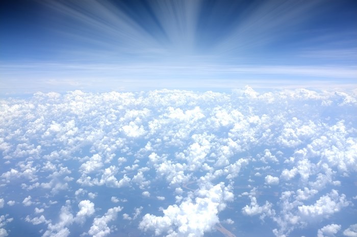 View from above the clouds with sun rays