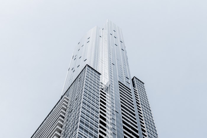 Modern skyscraper against a pale sky