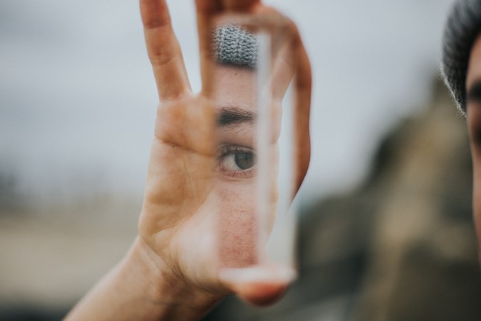 Person holding a prism to their eye