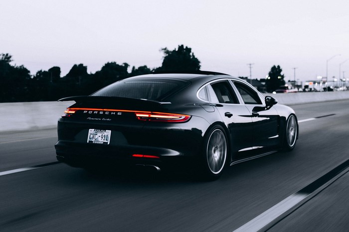 Black Porsche Panamera Turbo driving on a highway
