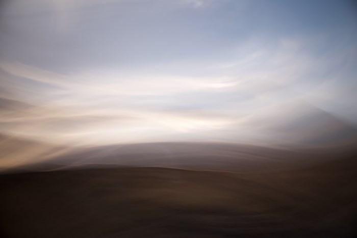 Blurry landscape with sky and horizon at sunset